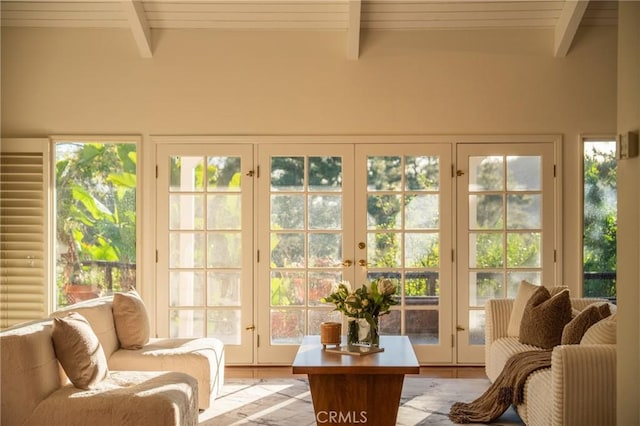 sunroom with beam ceiling and french doors