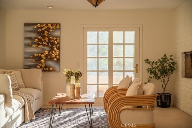 sitting room featuring carpet flooring and a fireplace