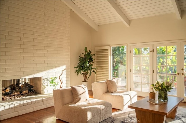 interior space featuring beam ceiling, a brick fireplace, and wood ceiling