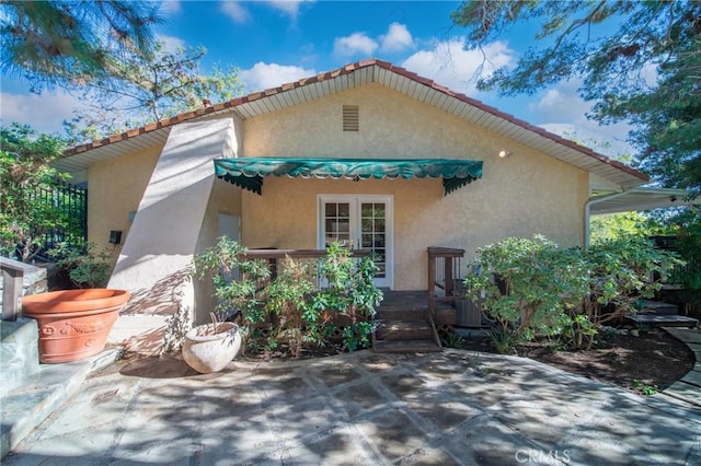 back of property featuring stucco siding and a patio