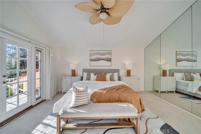 bedroom with multiple windows, light colored carpet, lofted ceiling, and access to outside