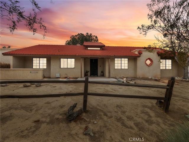 mediterranean / spanish-style home featuring stucco siding and a tiled roof