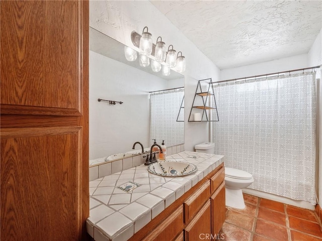 bathroom with vanity, curtained shower, toilet, and a textured ceiling