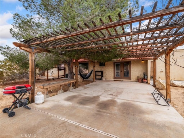 view of patio / terrace with a carport, a grill, french doors, and a pergola