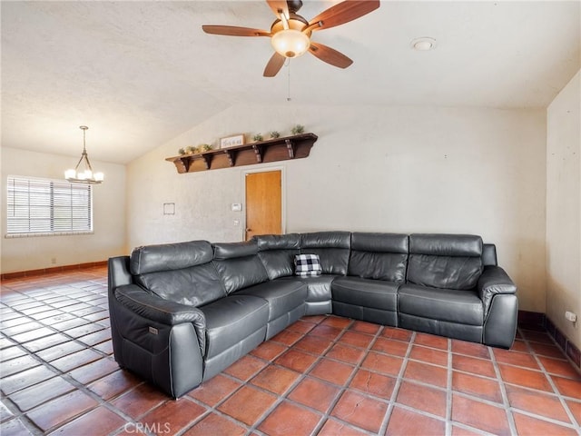 living area with baseboards, ceiling fan with notable chandelier, and vaulted ceiling