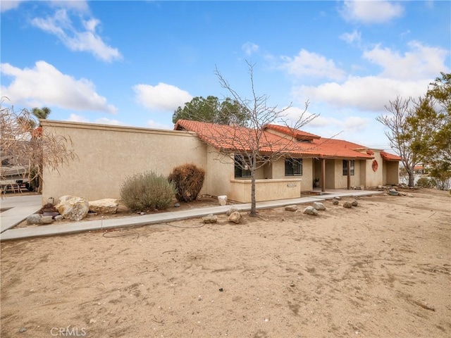 view of front of property with stucco siding and a tiled roof