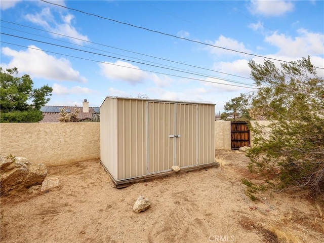 view of shed with fence