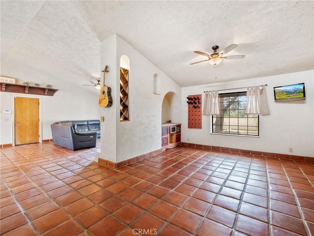 unfurnished room featuring tile patterned flooring, a textured ceiling, and ceiling fan