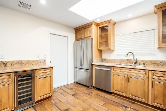6432 Weber Cir, Huntington Beach, CA 92647 - kitchen with a sink, stainless steel appliances, light wood-type flooring, visible vents, and wine cooler