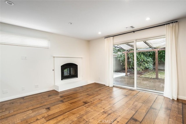 6432 Weber Cir, Huntington Beach, CA 92647 - unfurnished living room with recessed lighting, wood-type flooring, a glass covered fireplace, and visible vents