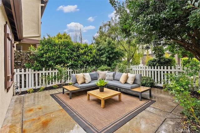 view of patio / terrace featuring an outdoor living space and fence