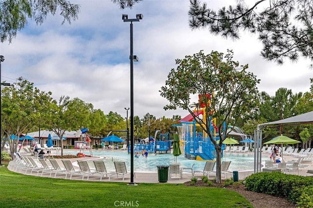 view of home's community featuring a lawn and playground community