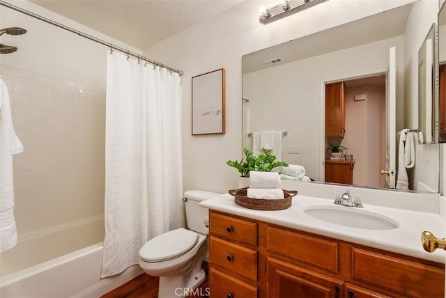 bathroom featuring visible vents, toilet, shower / tub combo with curtain, and vanity