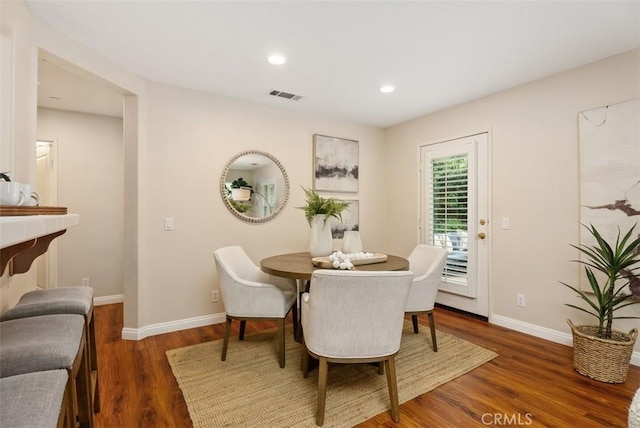 dining area with recessed lighting, wood finished floors, visible vents, and baseboards