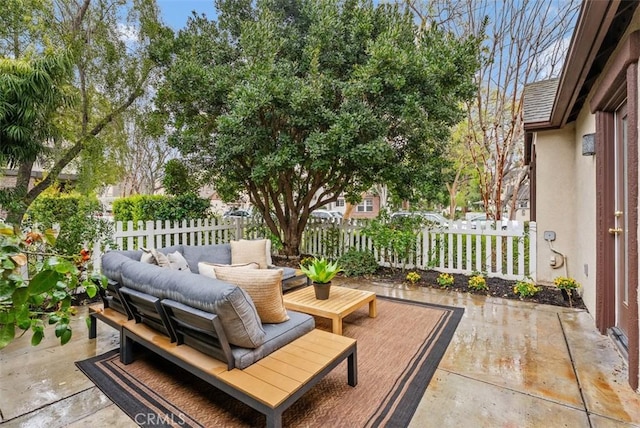 view of patio / terrace with an outdoor living space and fence