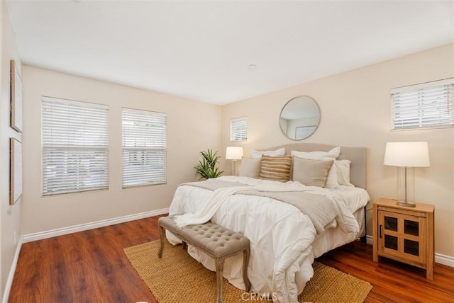 bedroom featuring baseboards and wood finished floors