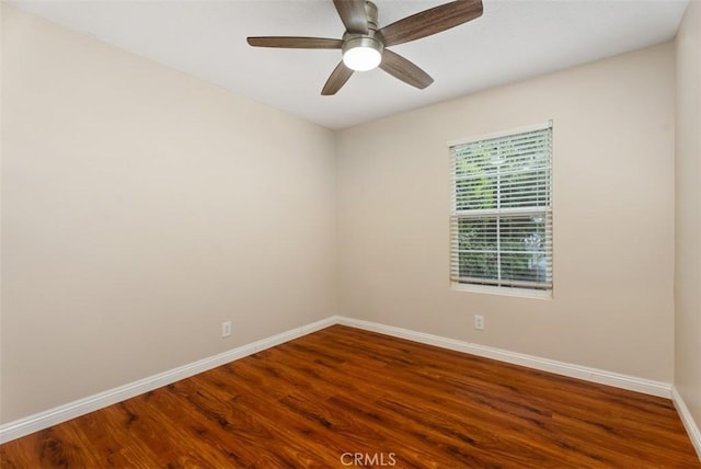 unfurnished room with ceiling fan, baseboards, and wood finished floors