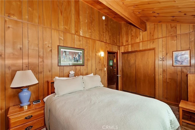 bedroom with wood ceiling, wood walls, and vaulted ceiling with beams