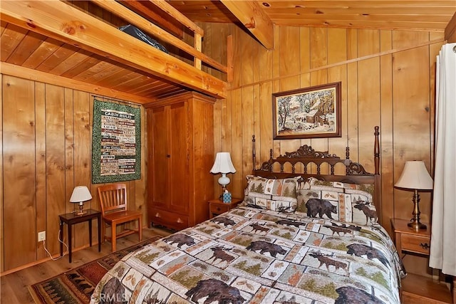 bedroom with wooden ceiling, wood finished floors, wood walls, and vaulted ceiling with beams