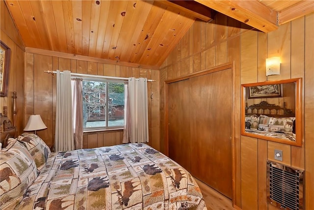 bedroom with wood walls, wood ceiling, lofted ceiling with beams, wood finished floors, and a closet