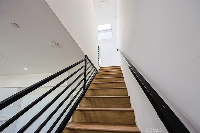 staircase with recessed lighting