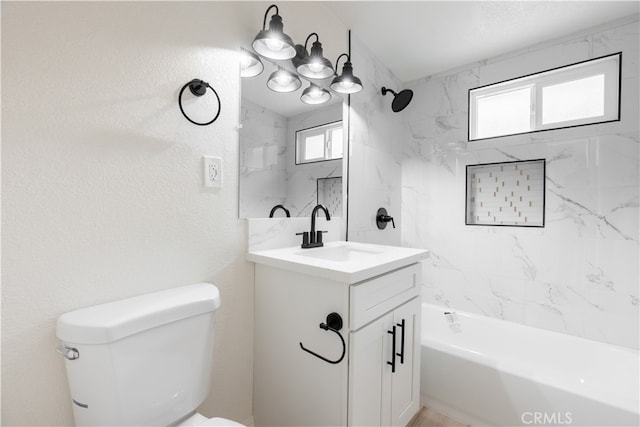 bathroom with a healthy amount of sunlight, toilet, vanity, and  shower combination