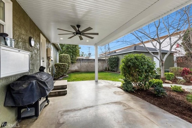 view of patio / terrace featuring a grill, an outdoor structure, ceiling fan, and fence