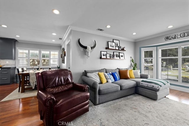 living area with visible vents, recessed lighting, crown molding, and dark wood-type flooring