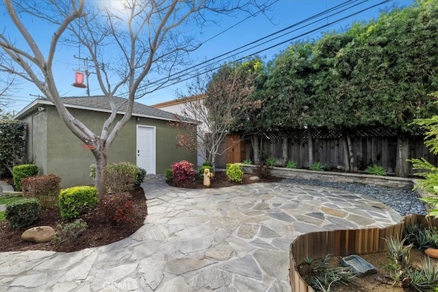 view of patio featuring an outbuilding and a fenced backyard