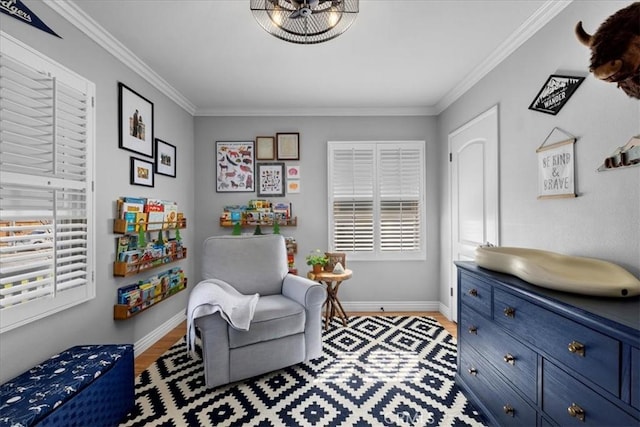 sitting room with a wealth of natural light, baseboards, and crown molding