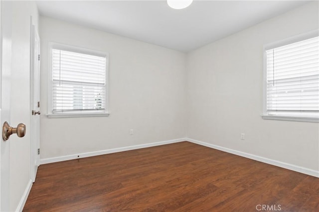 unfurnished room featuring wood finished floors and baseboards