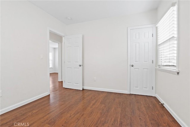 unfurnished bedroom with baseboards and wood finished floors