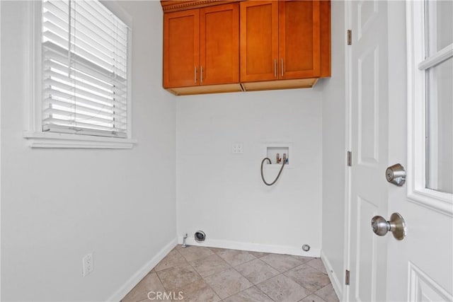 washroom with hookup for a washing machine, light tile patterned flooring, cabinet space, and baseboards