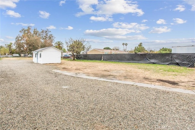 view of yard with an outbuilding and fence