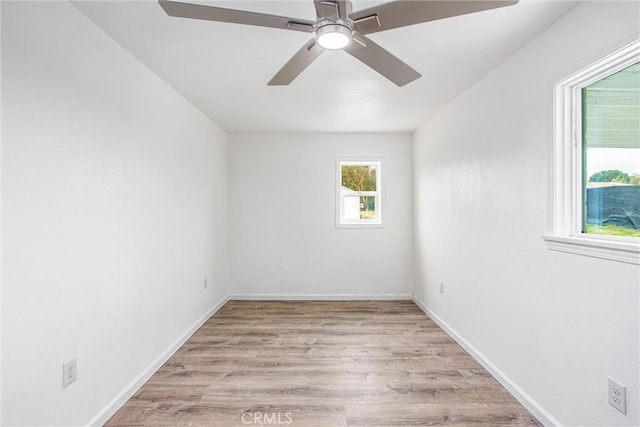 unfurnished room with baseboards, wood finished floors, and ceiling fan