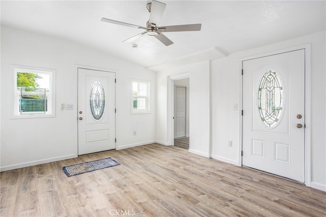 foyer entrance featuring vaulted ceiling, baseboards, light wood-type flooring, and ceiling fan