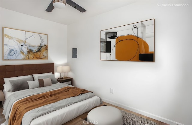 bedroom with wood finished floors, baseboards, and ceiling fan