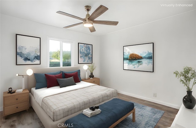 bedroom featuring ceiling fan, baseboards, and wood finished floors