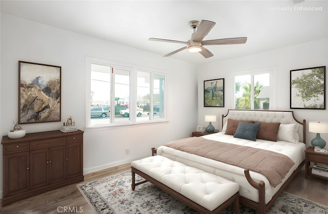 bedroom with baseboards, light wood finished floors, and ceiling fan