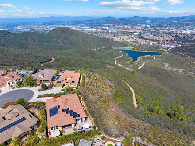 birds eye view of property with a water and mountain view