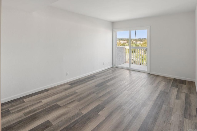 unfurnished room with wood finished floors and baseboards