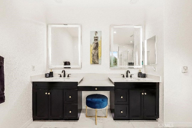 full bath featuring baseboards, vanity, and a shower