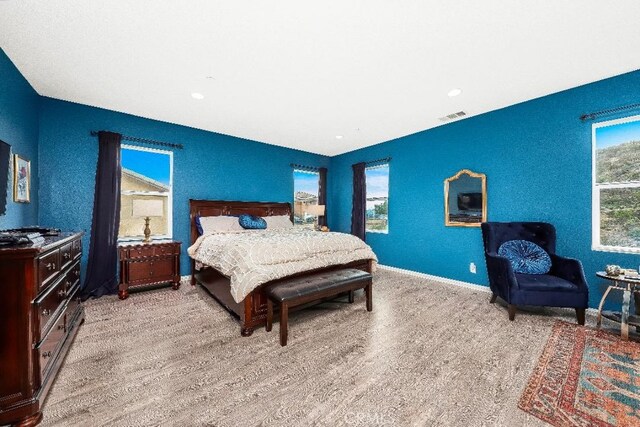 bedroom featuring baseboards and light wood-type flooring