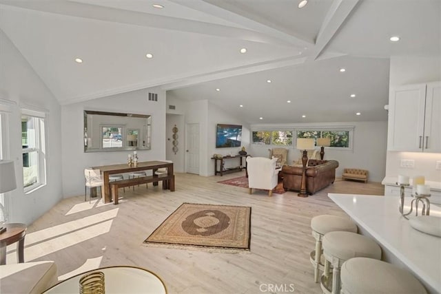 living area with visible vents, high vaulted ceiling, beam ceiling, light wood-style flooring, and recessed lighting