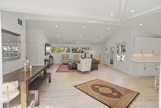 living area featuring visible vents, plenty of natural light, and light wood-style flooring