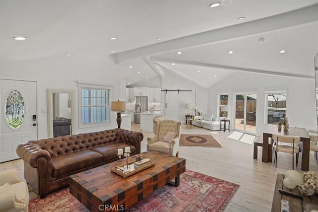 living area with lofted ceiling with beams, recessed lighting, and light wood-type flooring