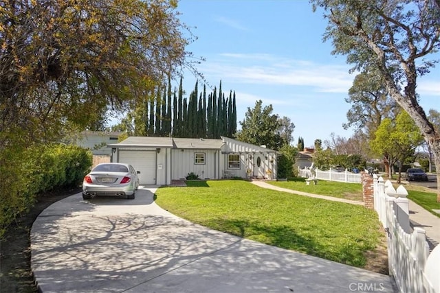 view of front of property with board and batten siding, a front lawn, fence, concrete driveway, and a garage