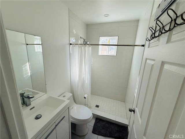 full bathroom featuring a stall shower, toilet, and vanity