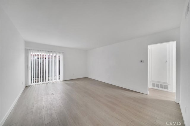 unfurnished room with visible vents, baseboards, and light wood finished floors