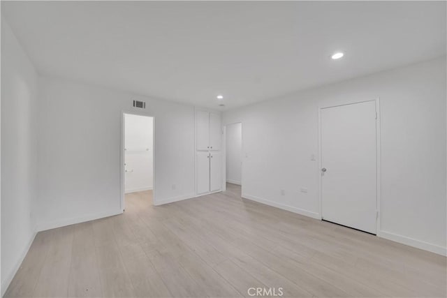 spare room featuring recessed lighting, visible vents, baseboards, and light wood-style floors